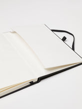 Load image into Gallery viewer, LDNA London black notebook opened up to show the storage pocket.